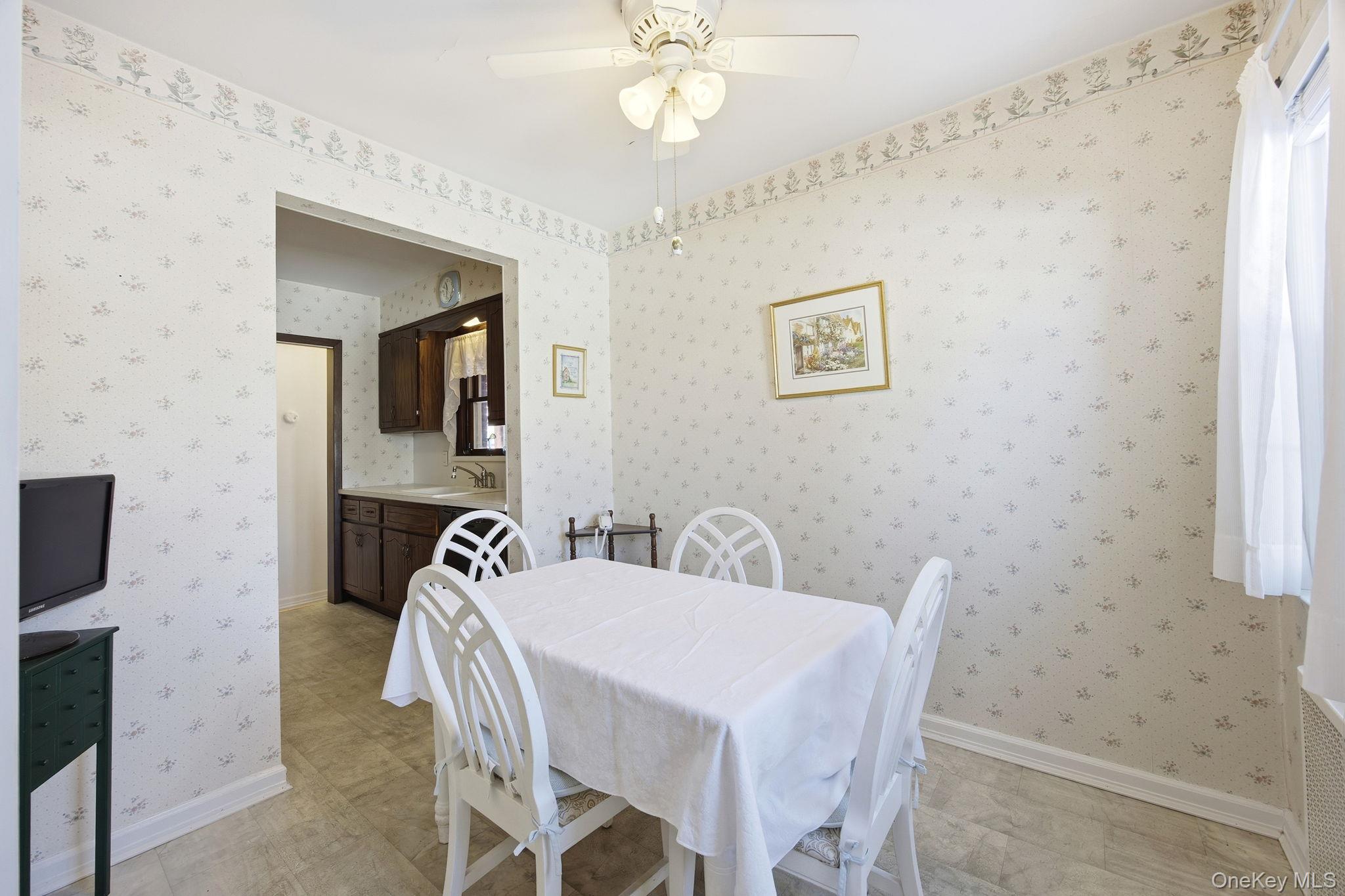 54 Aberdeen Road New Hyde Park, NY 11040 - Photo 11 of 26 a view of a dining room with furniture and a chandelier fan