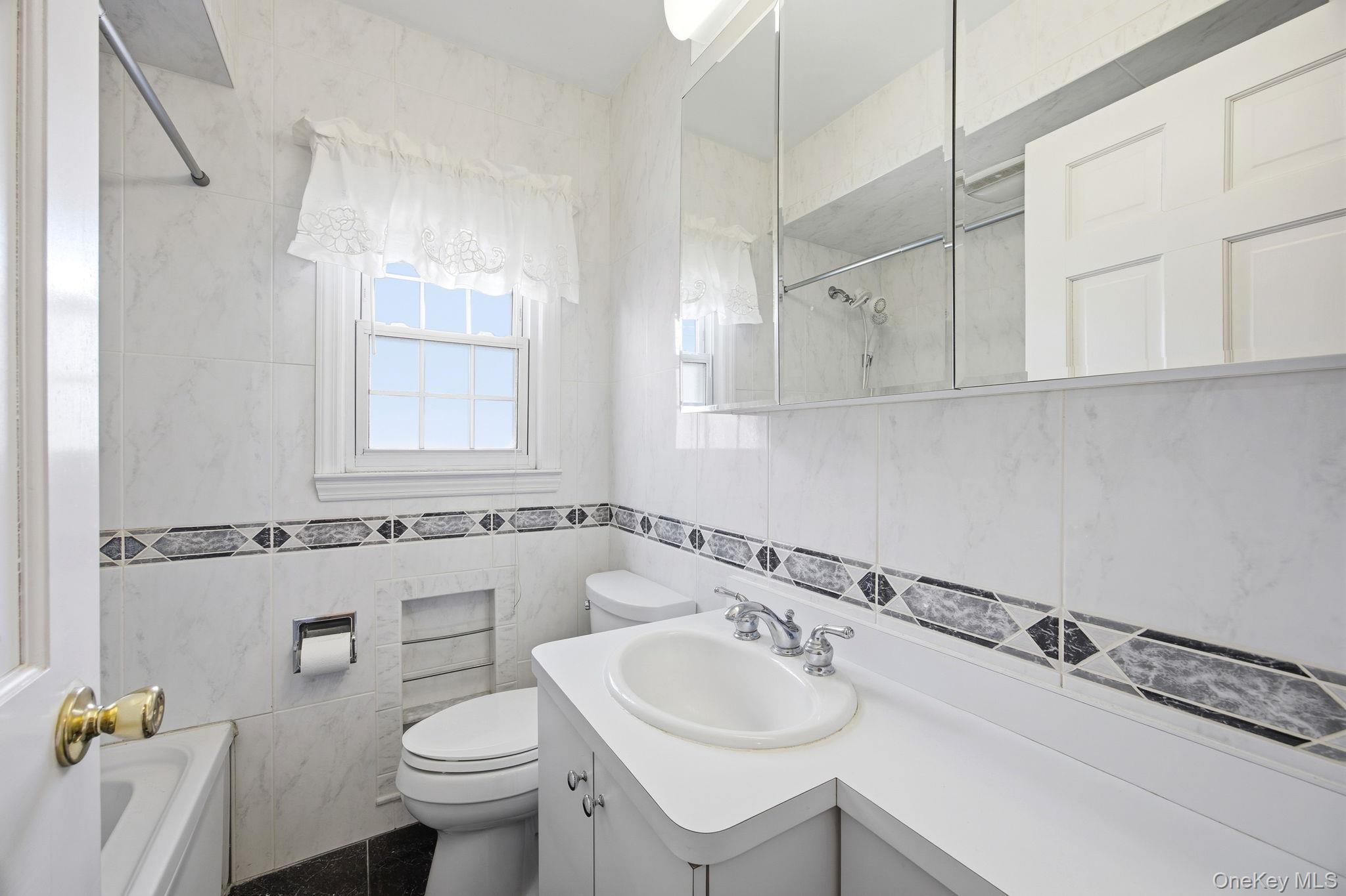 54 Aberdeen Road New Hyde Park, NY 11040 - Photo 12 of 26 a bathroom with a sink and a toilet