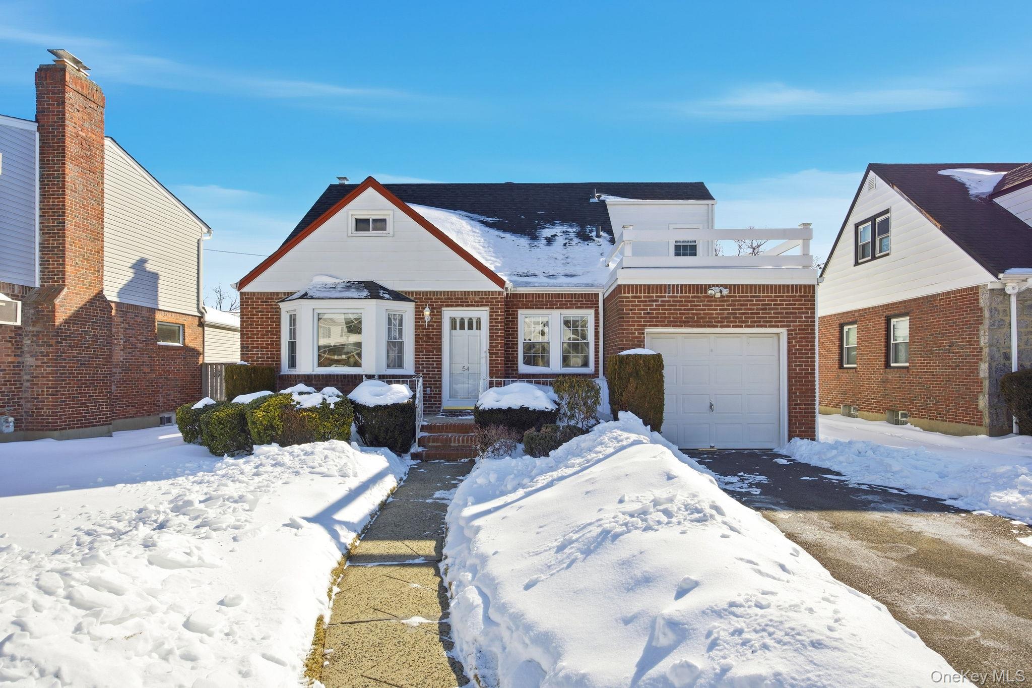 54 Aberdeen Road New Hyde Park, NY 11040 - Photo 2 of 26 a view of a house with a snow in the background