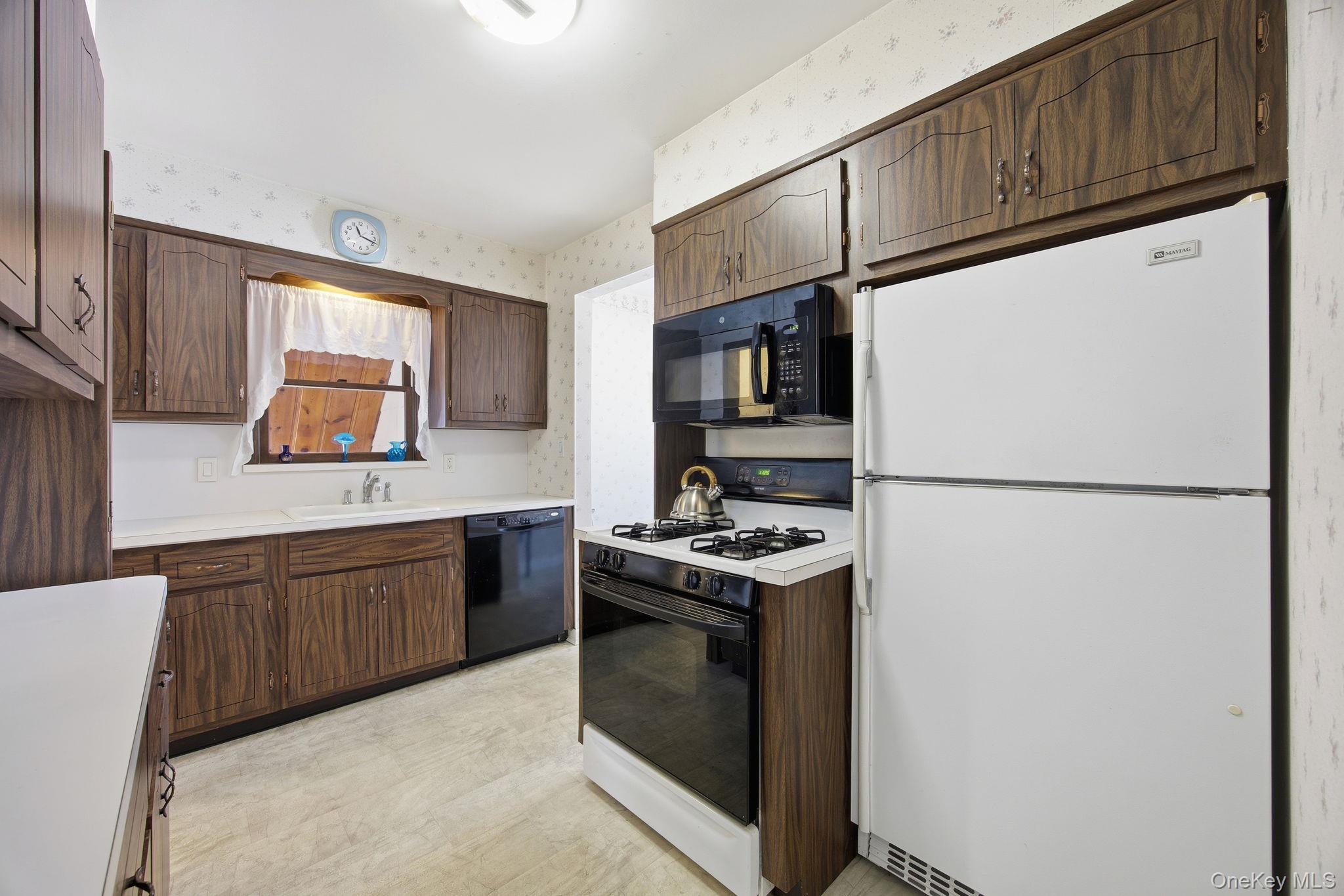 54 Aberdeen Road New Hyde Park, NY 11040 - Photo 8 of 26 a kitchen with stainless steel appliances granite countertop a refrigerator a stove a sink and a microwave