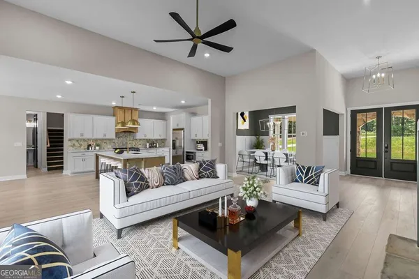 a living room with furniture and kitchen view