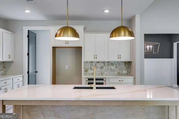 a kitchen with a sink a counter and cabinets
