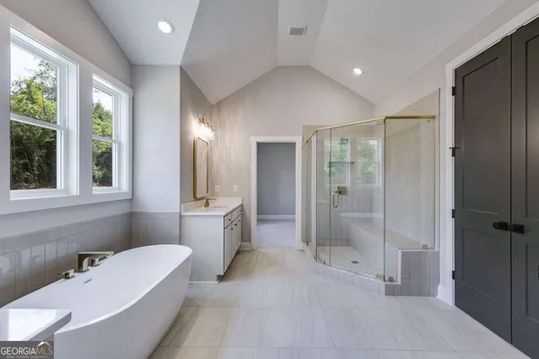 a bathroom with a bathtub shower sink and toilet