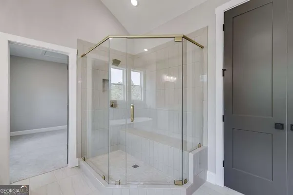 a bathroom that has a glass shower door