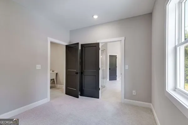 an empty room with windows and closet