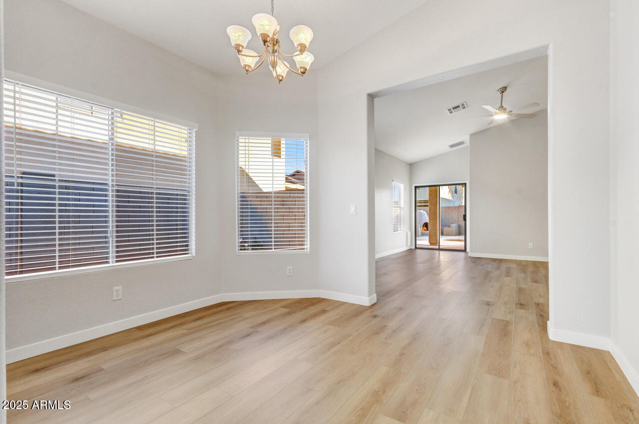 13431 West Evans Drive Surprise, AZ 85379 - Photo 14 of 37 a view of an empty room with a window and wooden floor