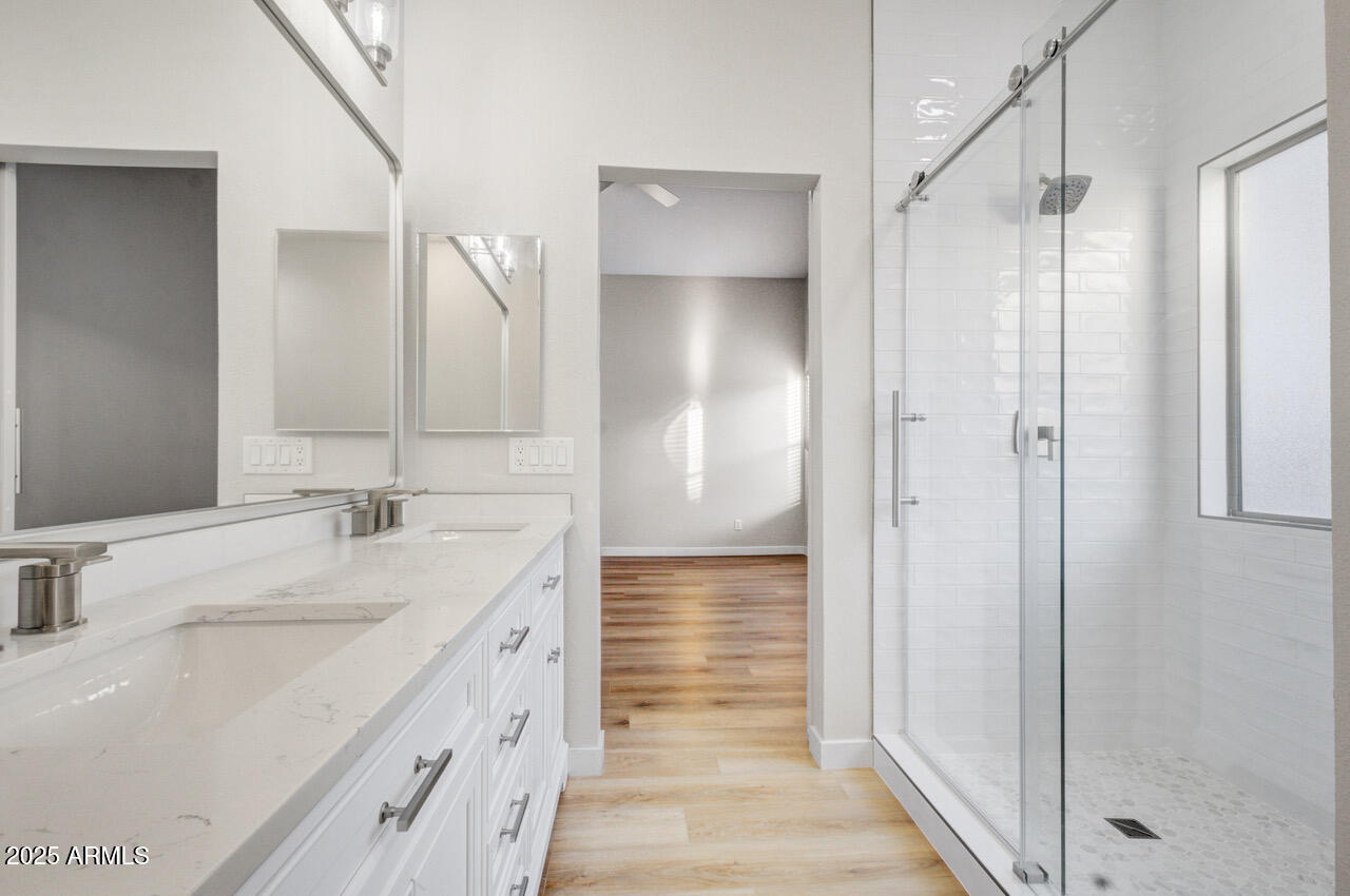 13431 West Evans Drive Surprise, AZ 85379 - Photo 19 of 37 a bathroom with a double vanity sink and mirror