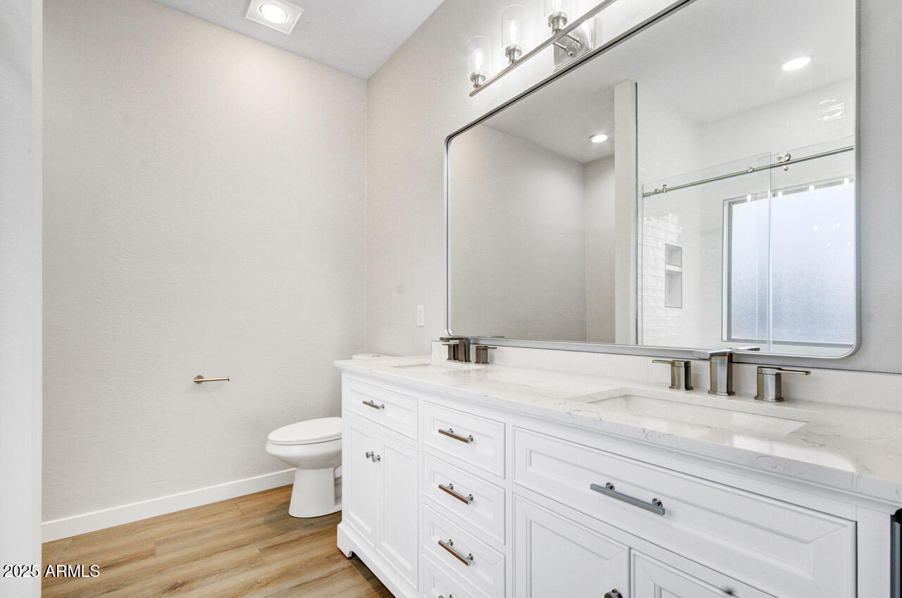 13431 West Evans Drive Surprise, AZ 85379 - Photo 20 of 37 a bathroom with a granite countertop sink a toilet and a mirror