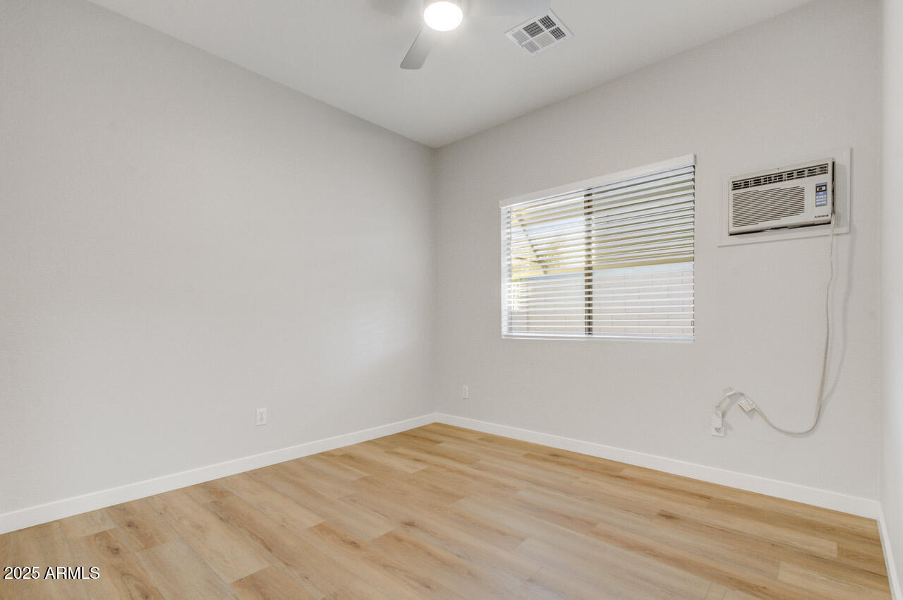 13431 West Evans Drive Surprise, AZ 85379 - Photo 25 of 37 a view of an empty room with wooden floor and a window