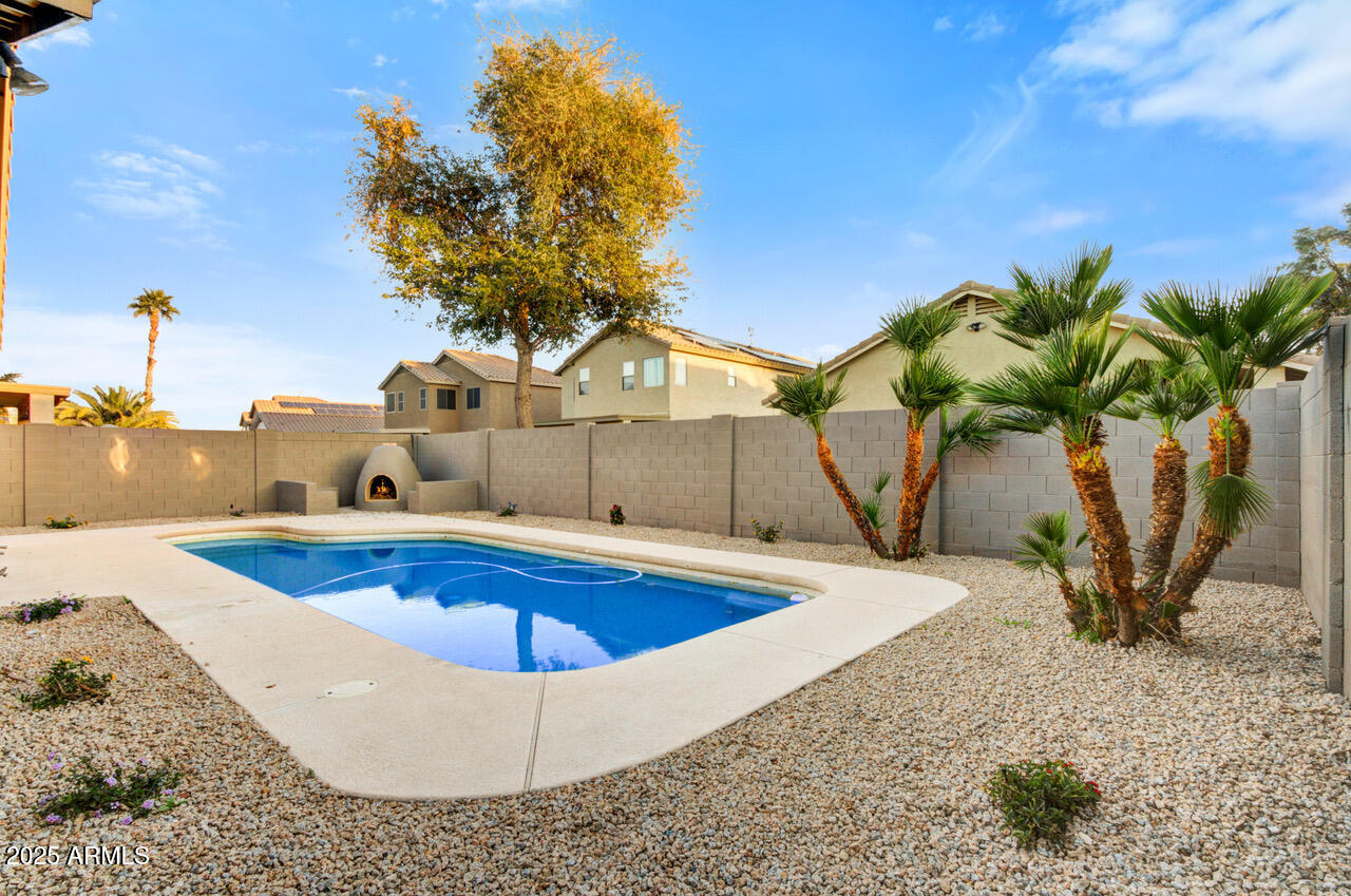 13431 West Evans Drive Surprise, AZ 85379 - Photo 30 of 37 a view of a swimming pool with a yard