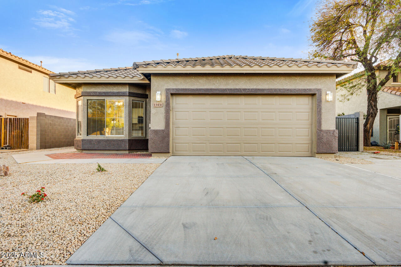 13431 West Evans Drive Surprise, AZ 85379 - Photo 3 of 37 a front view of a house with a garage