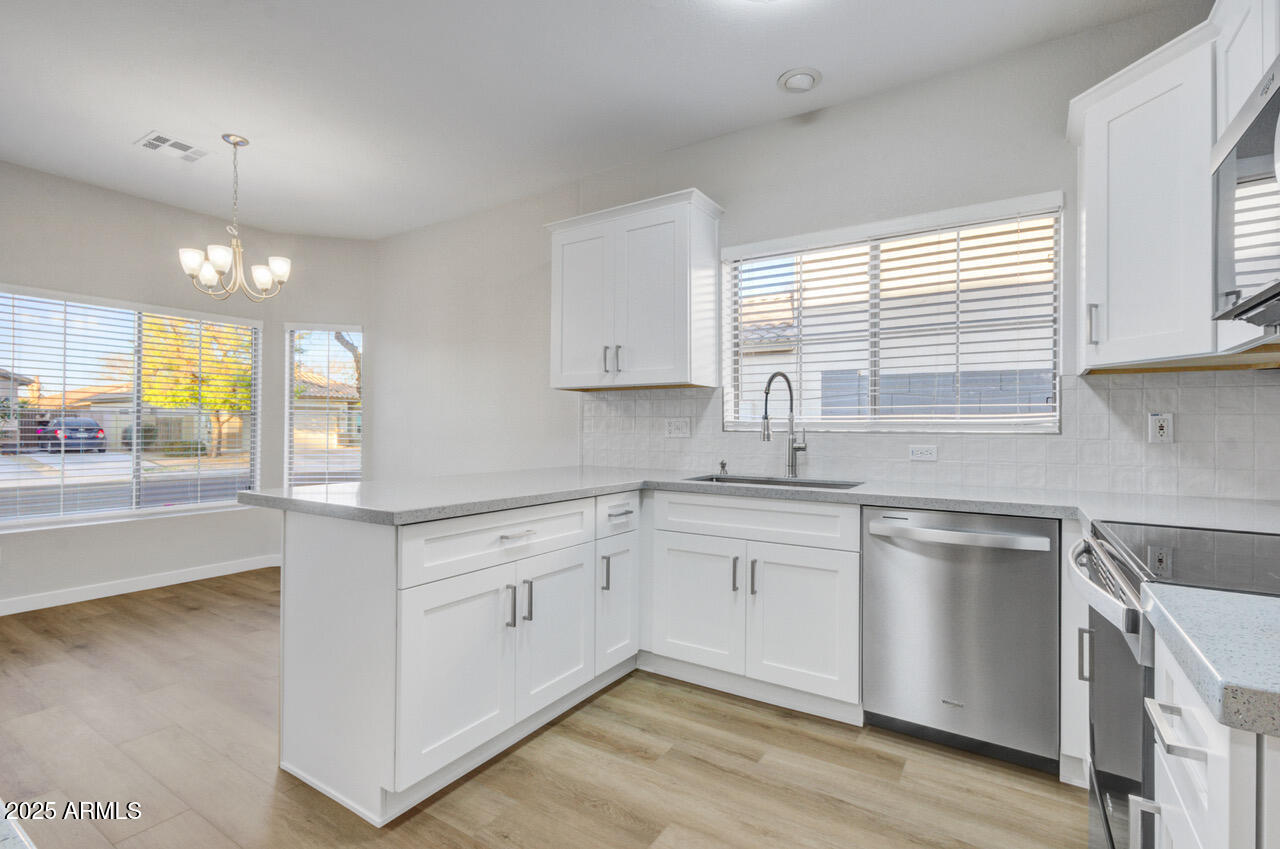13431 West Evans Drive Surprise, AZ 85379 - Photo 6 of 37 a kitchen with a sink cabinets and window