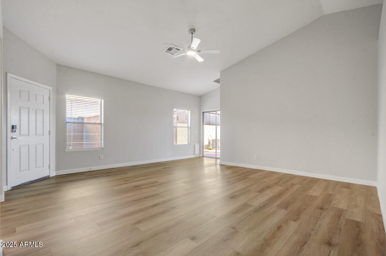 13431 West Evans Drive Surprise, AZ 85379 - Photo 9 of 37 a view of an empty room with wooden floor and a window