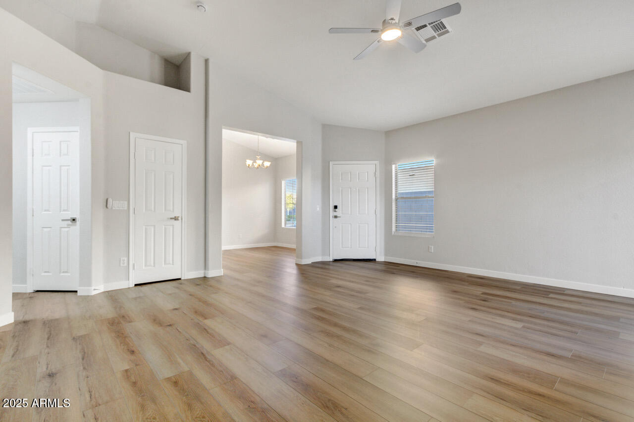 13431 West Evans Drive Surprise, AZ 85379 - Photo 10 of 37 a view of an empty room with wooden floor