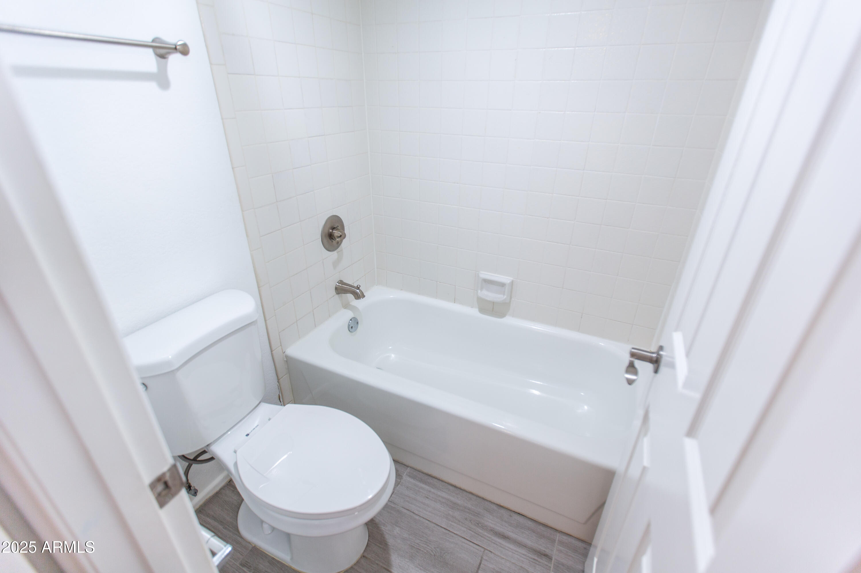 1402 East Guadalupe Road, Unit 153 Tempe, AZ 85283 - Photo 16 of 25 a white toilet sitting next to a bath tub