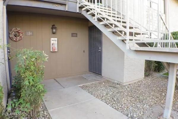 a front view of a house with plants