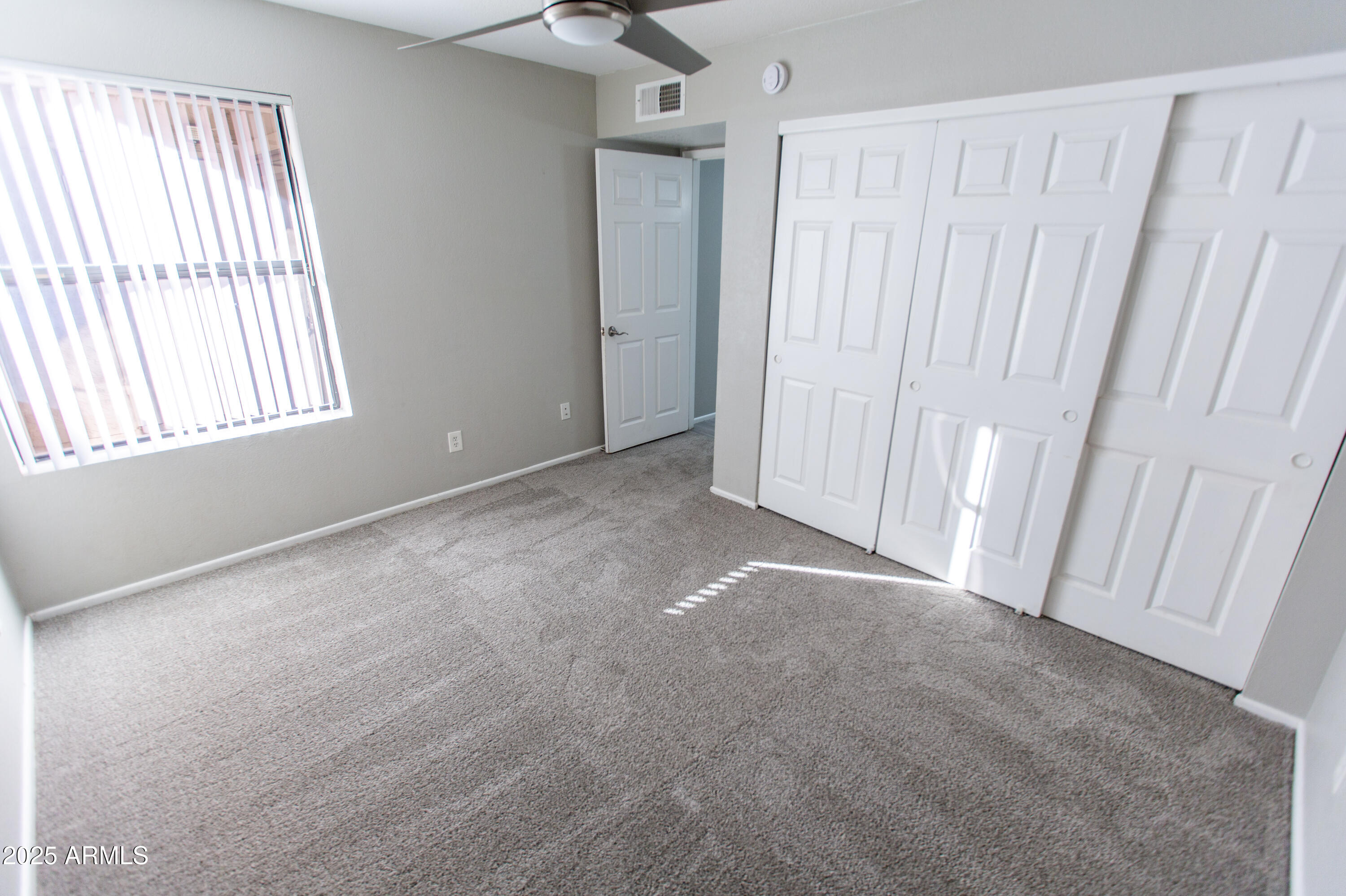 1402 East Guadalupe Road, Unit 153 Tempe, AZ 85283 - Photo 18 of 25 an empty room with windows