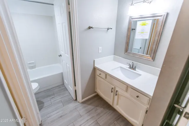 a bathroom with a sink a mirror and a bathtub
