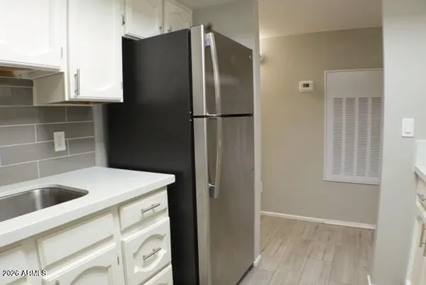 a kitchen with stainless steel appliances granite countertop a refrigerator and a sink