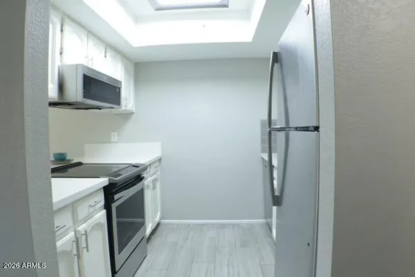 a kitchen with a sink and a microwave