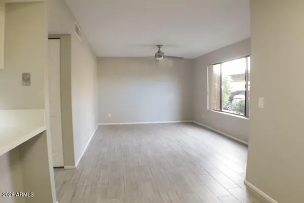 wooden floor in an empty room with a window