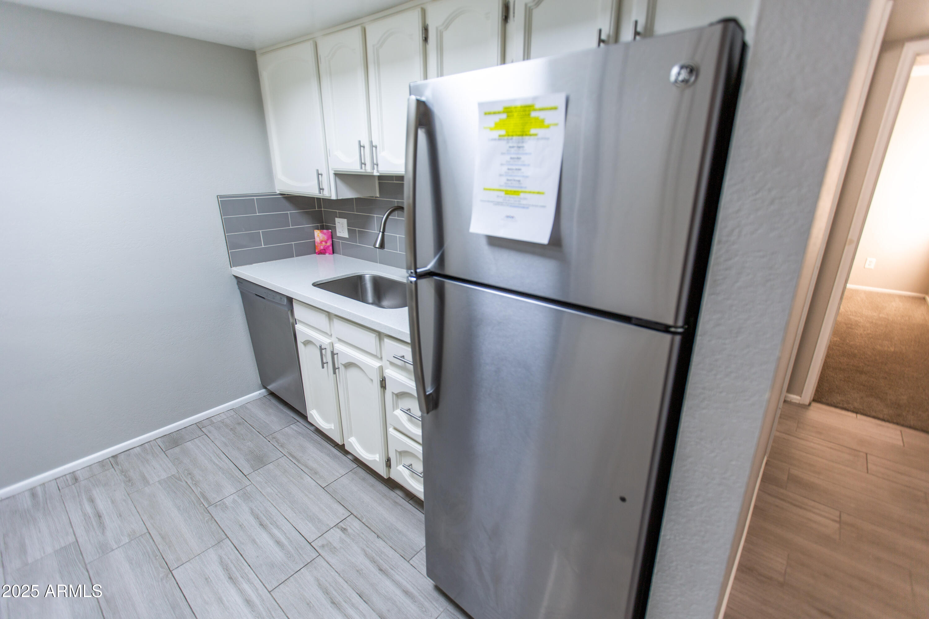 1402 East Guadalupe Road, Unit 153 Tempe, AZ 85283 - Photo 7 of 25 a kitchen with stainless steel appliances a refrigerator and a stove