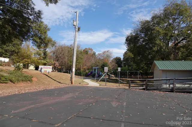 a white house that has a tree on the side of it
