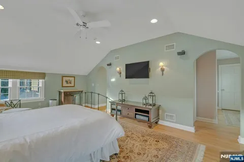 a bedroom with a bed and a mirror