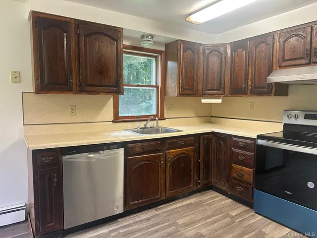 a kitchen with a sink cabinets and window