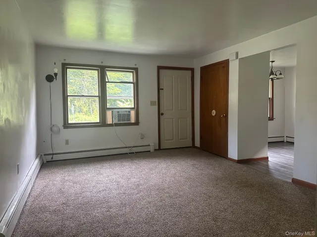 an empty room with windows and closet