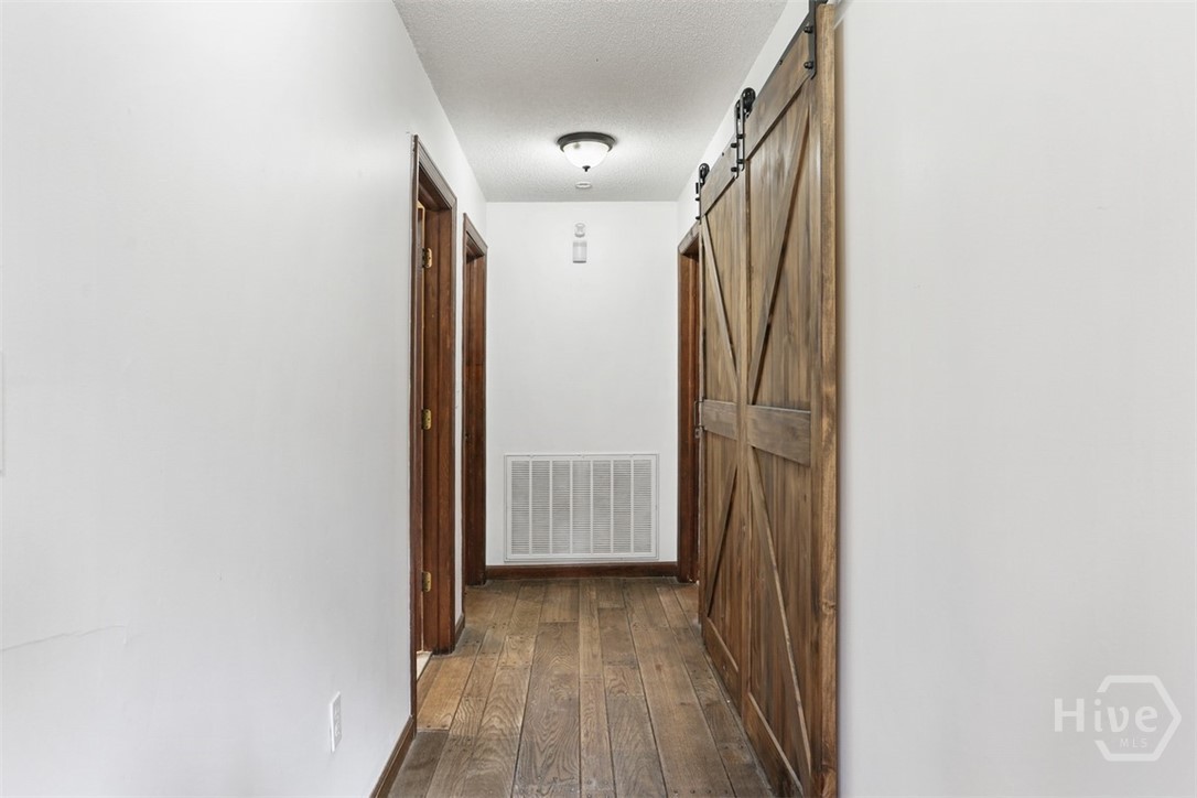 24 Crisp Street Savannah, GA 31410 - Photo 19 of 50 Downstairs hallway to guest bedrooms, 2 full bathrooms, and laundry closet
