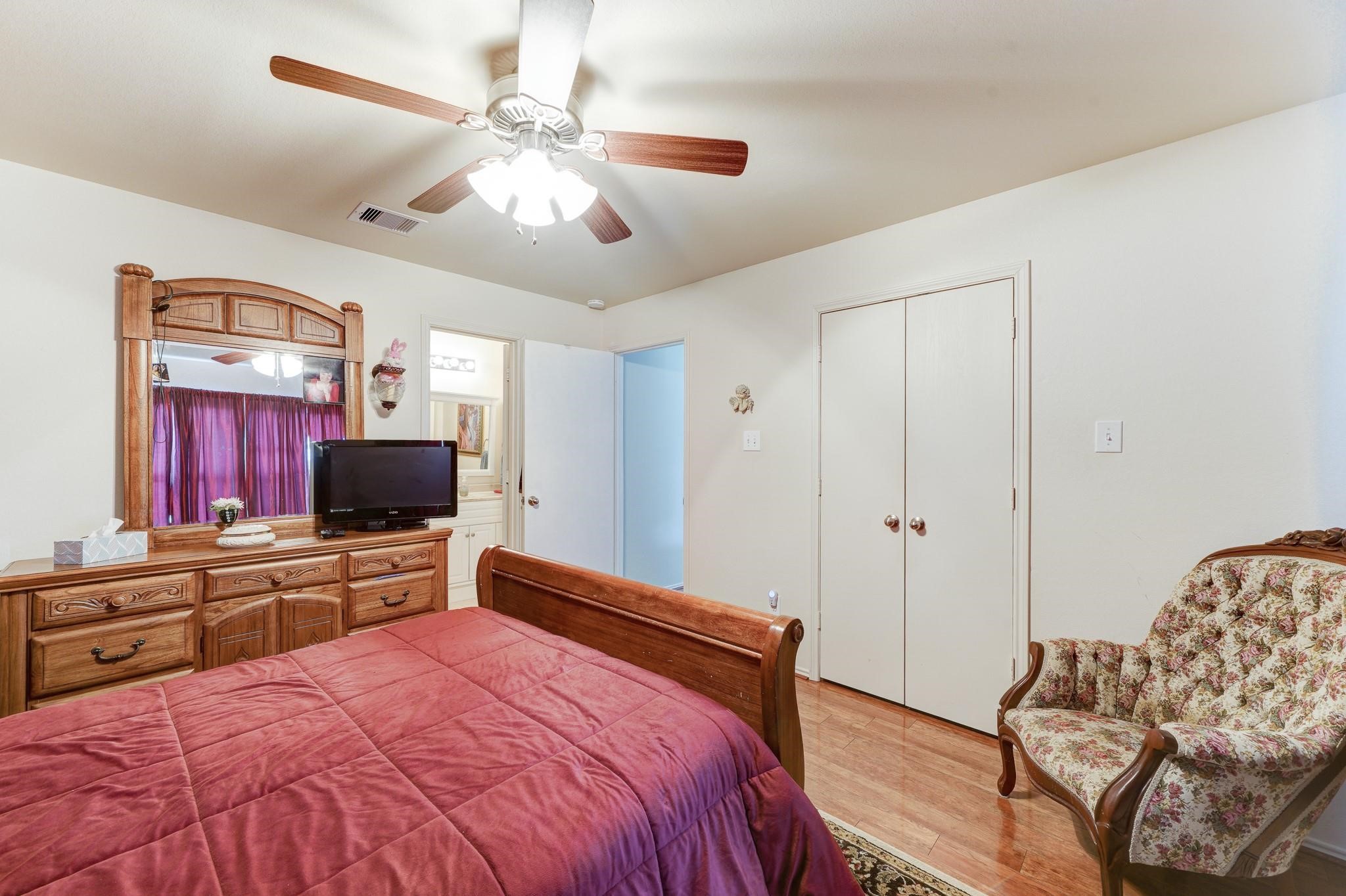1934 Robcrest Way Missouri City, TX 77489 - Photo 12 of 24 a bedroom with a bed and a flat screen tv