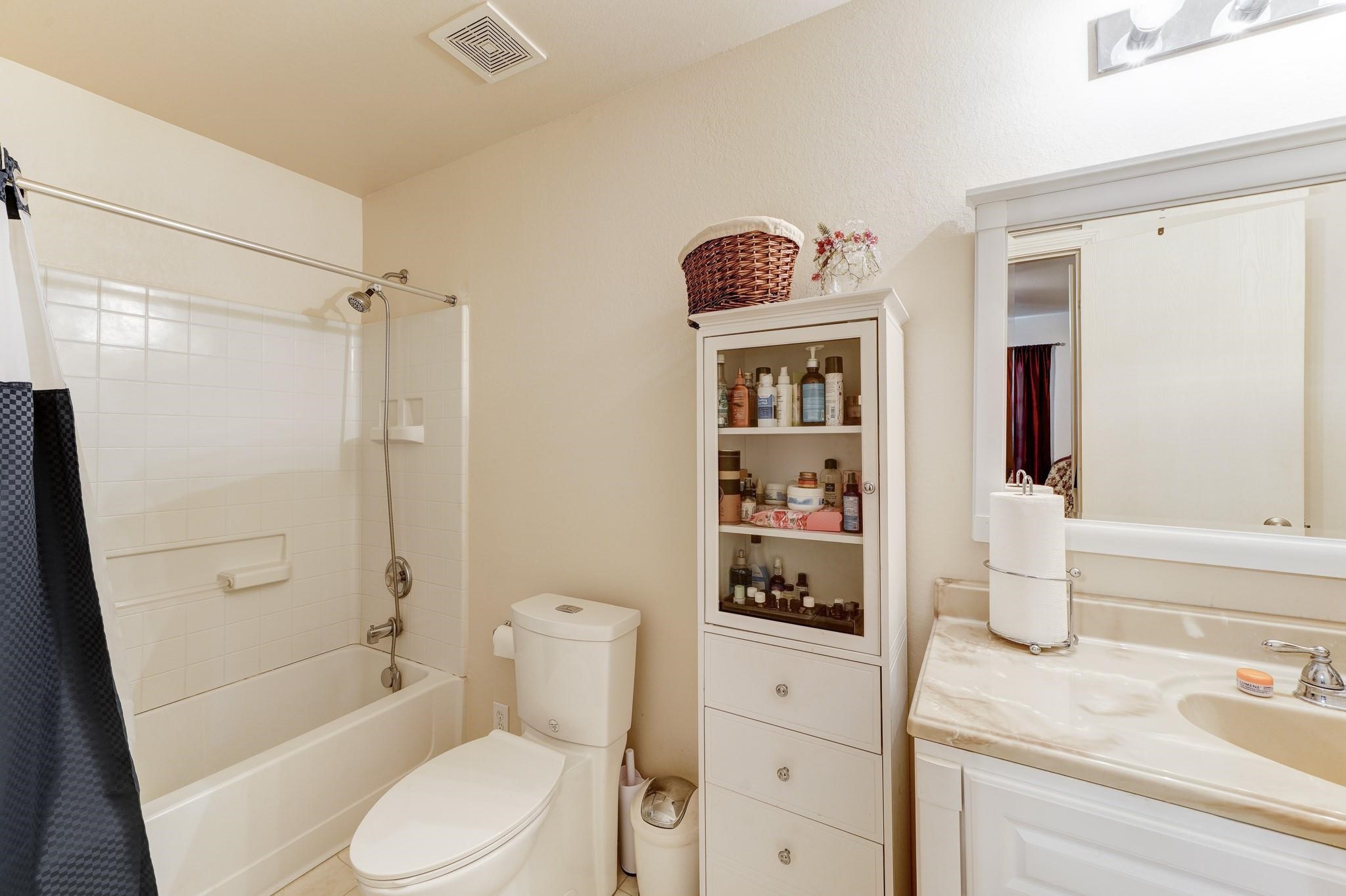 1934 Robcrest Way Missouri City, TX 77489 - Photo 13 of 24 a bathroom with a sink a toilet and shower