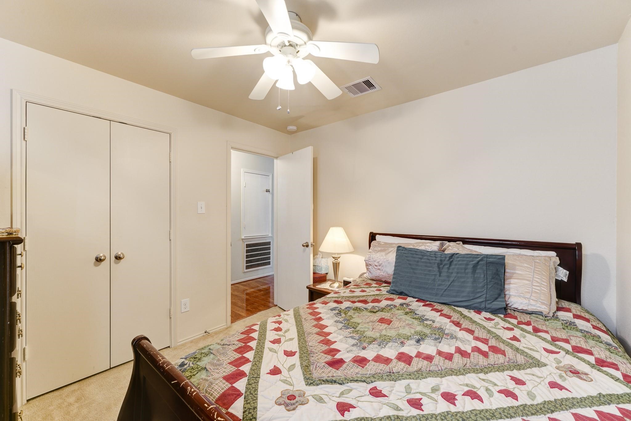 1934 Robcrest Way Missouri City, TX 77489 - Photo 14 of 24 a bedroom with a bed and a chandelier