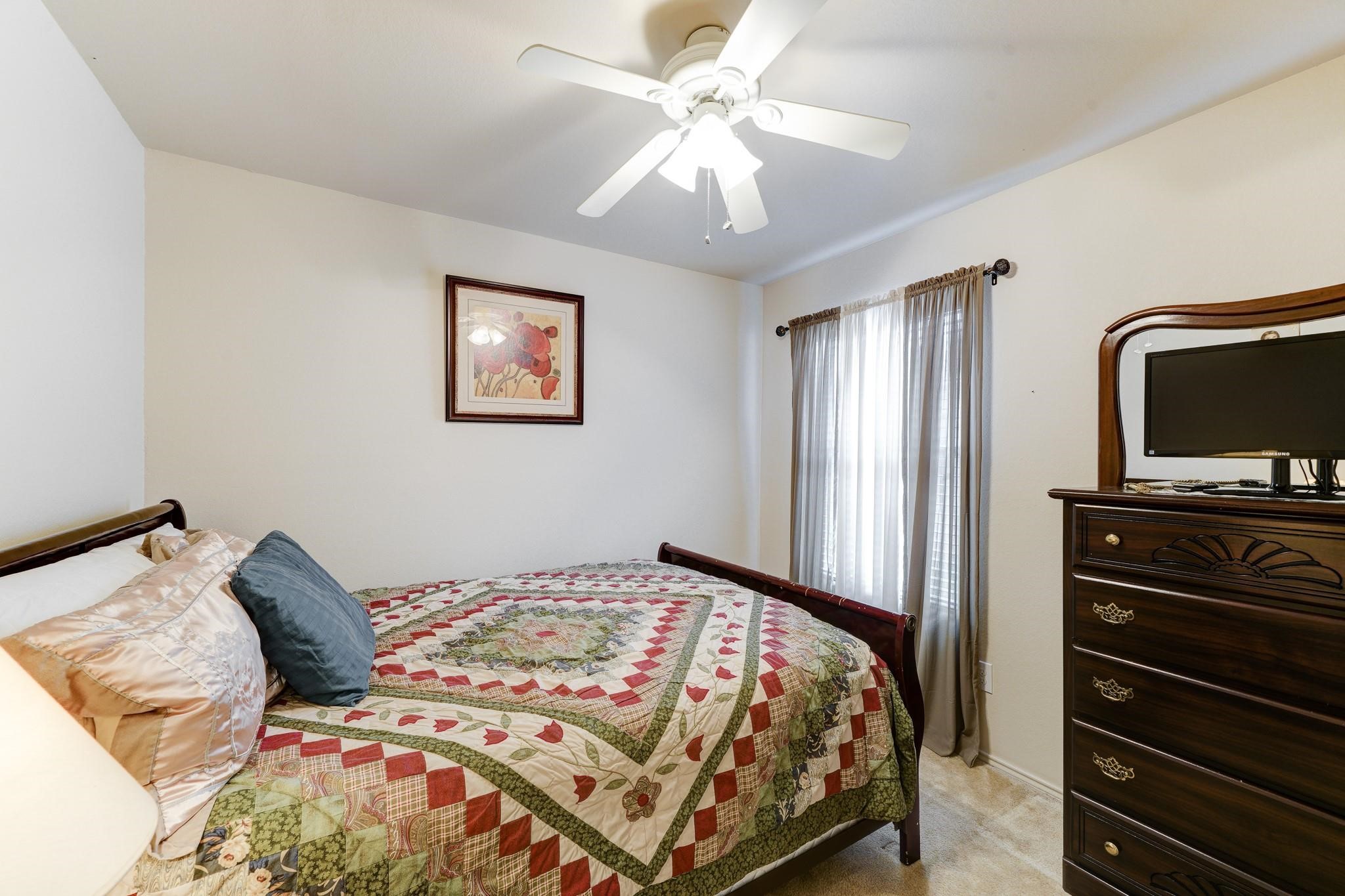 1934 Robcrest Way Missouri City, TX 77489 - Photo 15 of 24 a bedroom with a bed and a flat screen tv