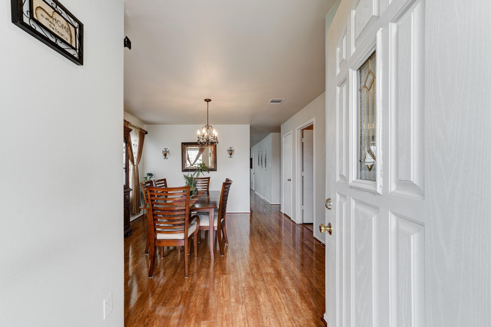 1934 Robcrest Way Missouri City, TX 77489 - Photo 3 of 24 a view of a dining room with furniture window and wooden floor