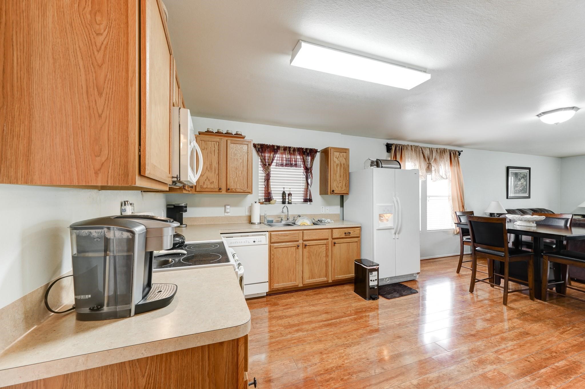 1934 Robcrest Way Missouri City, TX 77489 - Photo 6 of 24 a kitchen with sink refrigerator and cabinets