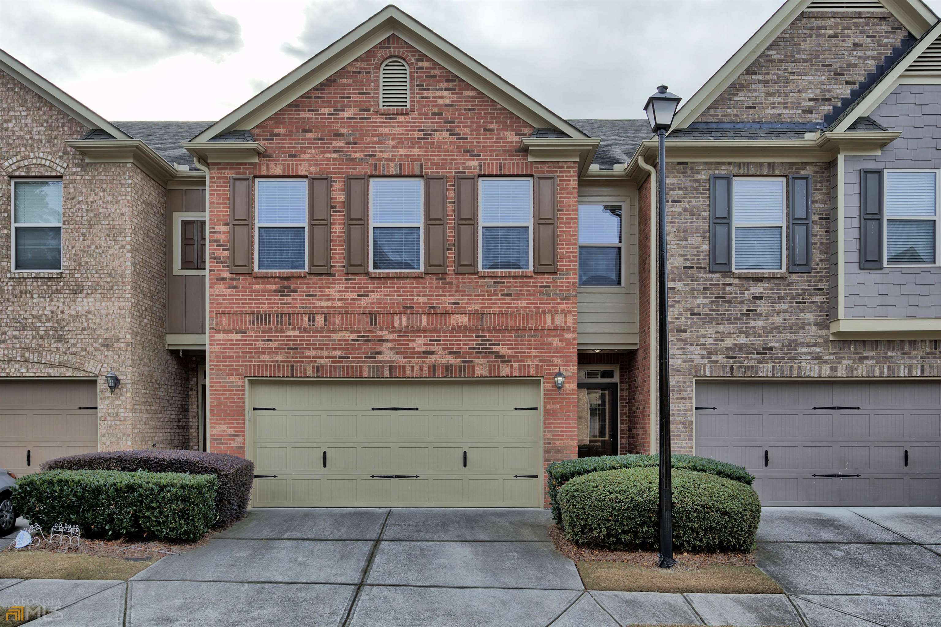 a front view of a house with garage