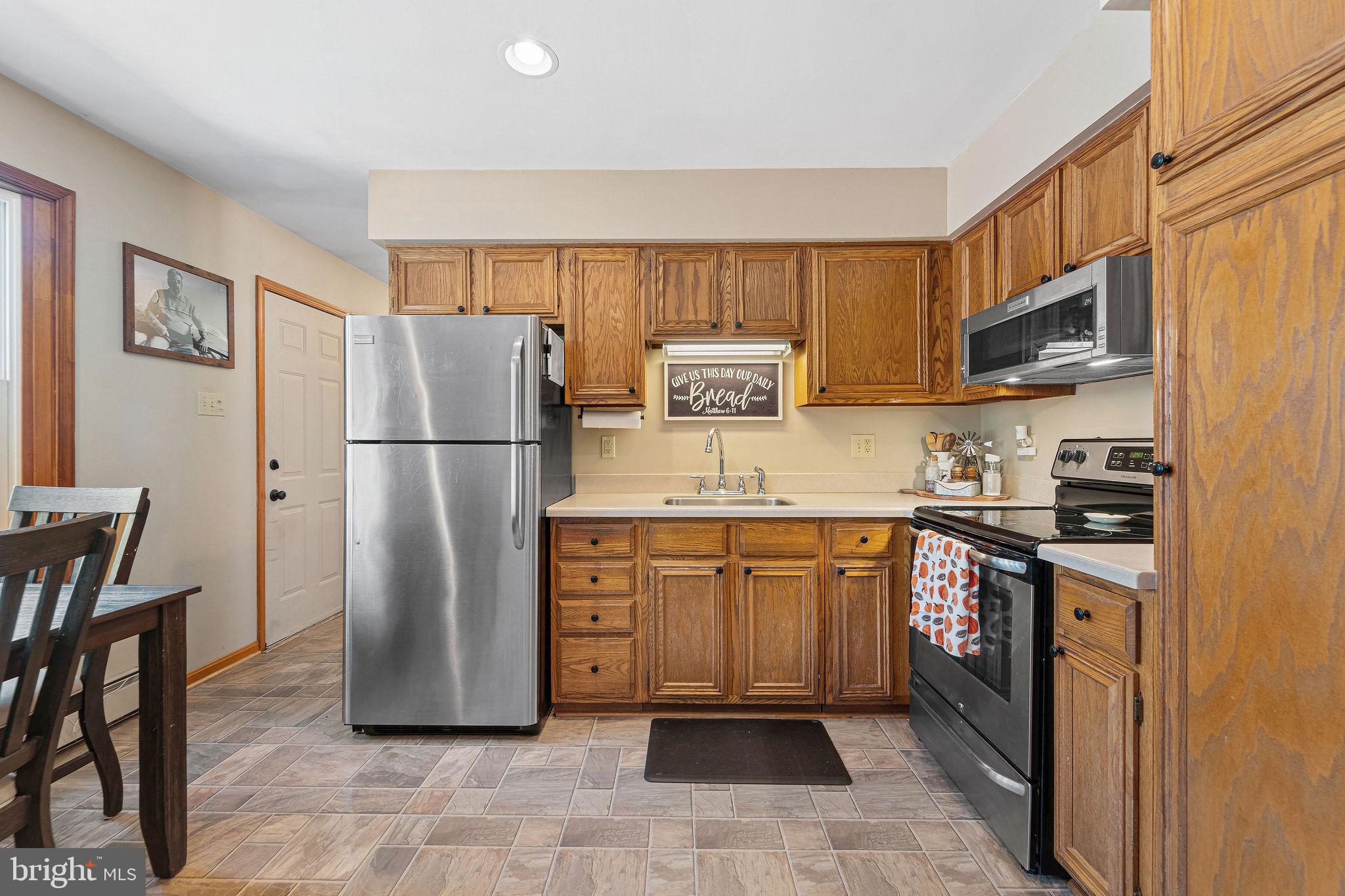 16 Laurel Trail Bridgeton, NJ 08302 - Photo 19 of 31 a kitchen with stainless steel appliances granite countertop a refrigerator stove a sink and a microwave
