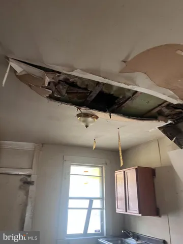 a view of walk in closet with window and entryway
