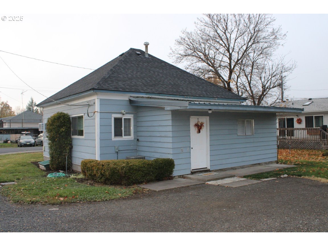 229 Darwin Street Athena, OR 97813 - Photo 1 of 18 a front view of a house with a yard and garage