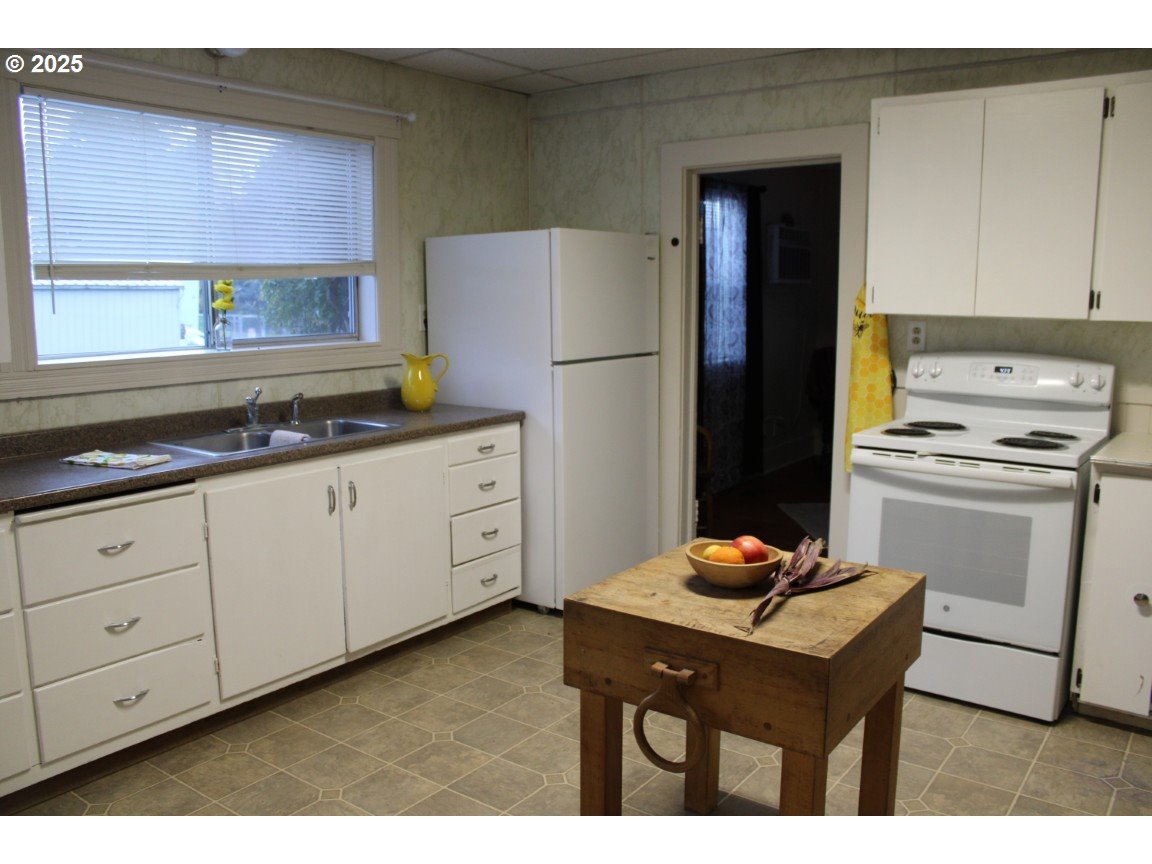 229 Darwin Street Athena, OR 97813 - Photo 6 of 18 a kitchen with stainless steel appliances granite countertop a refrigerator sink and cabinets