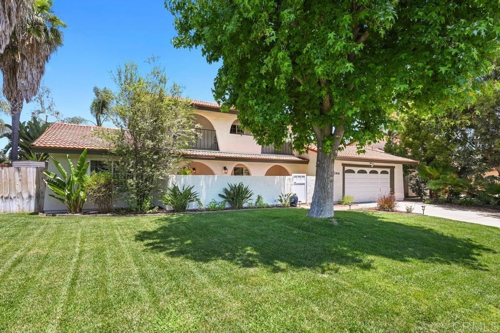 1064 Fulton Road San Marcos, CA 92069 - Photo 1 of 1 a front view of a house with a yard and trees