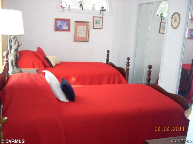 13824 Cross County Road Mineral, VA 23117 - Photo 9 of 12 a bedroom with a bed and wooden floor
