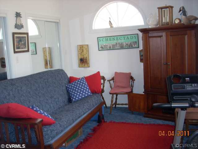 13824 Cross County Road Mineral, VA 23117 - Photo 10 of 12 a living room with furniture a flat screen tv and a stove