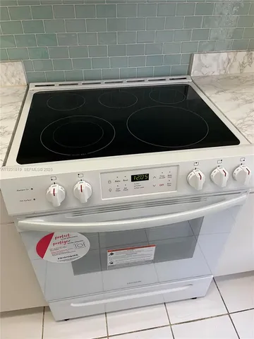 a stove top oven sitting inside of a kitchen