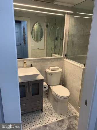 a bathroom with a toilet and a shower