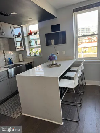 a large kitchen with a table and chairs