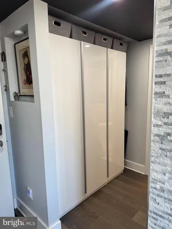 a view of a hallway with wooden floor and front door