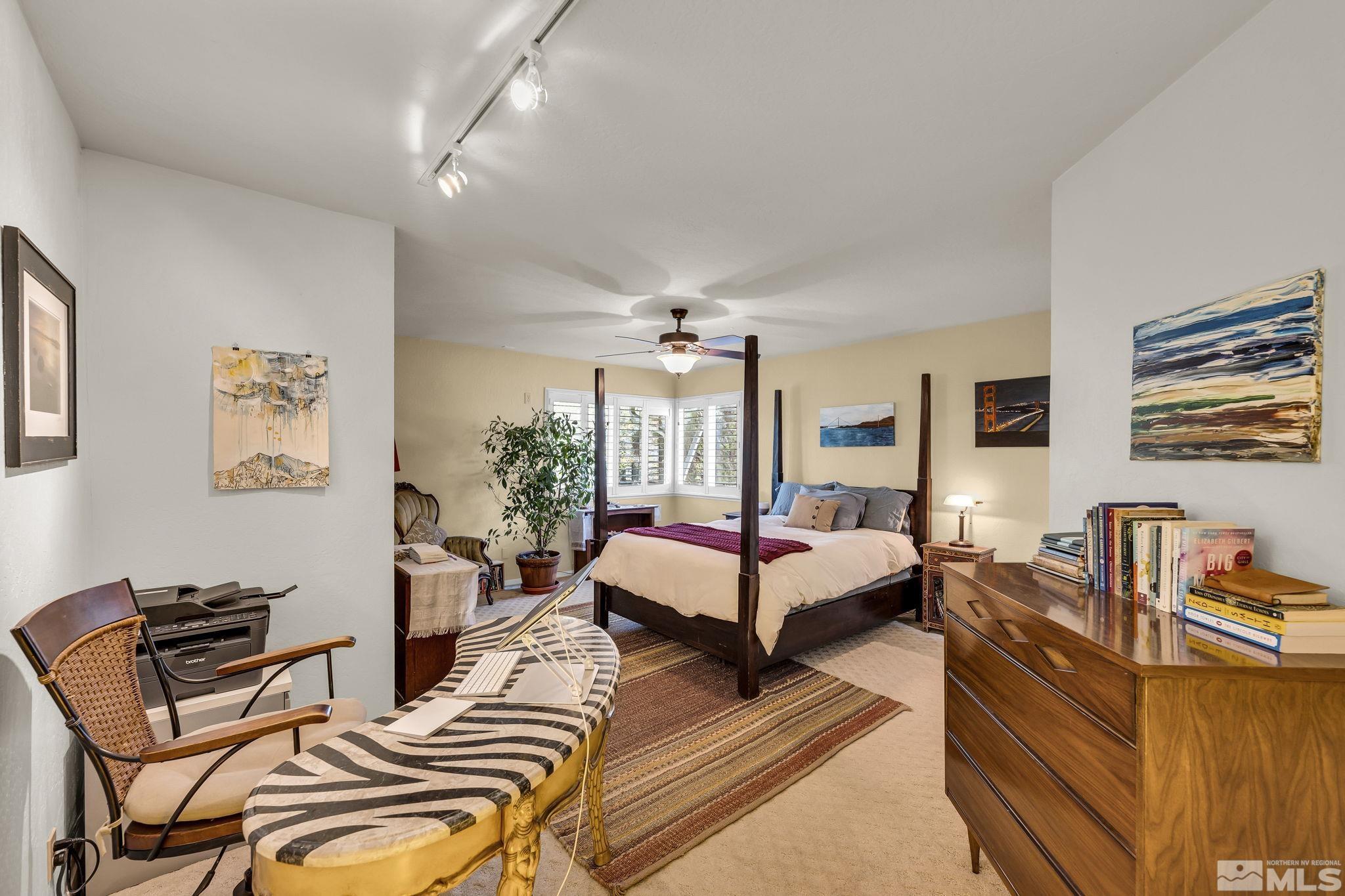 1485 Coronet Drive Reno, NV 89509 - Photo 19 of 38 a spacious bedroom with a bed a couch and dresser